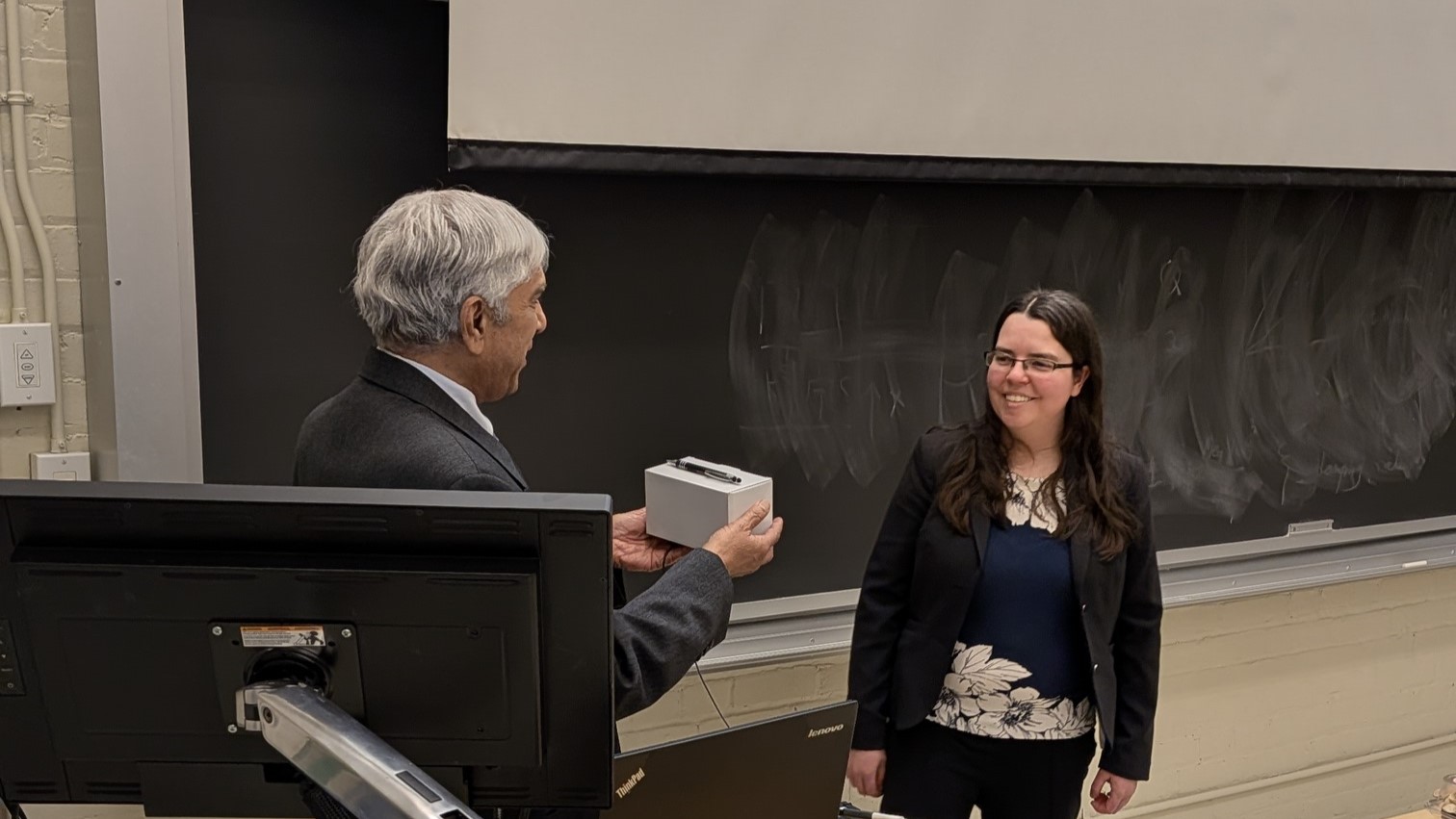 Dr. Marina Freire-Gormaly receiving a small token of thanks from PEOWT chapter