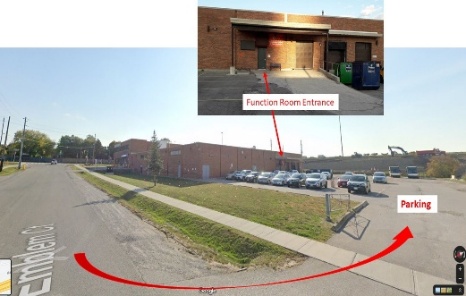 A building with a garage and parking lot
AI-generated content may be incorrect.