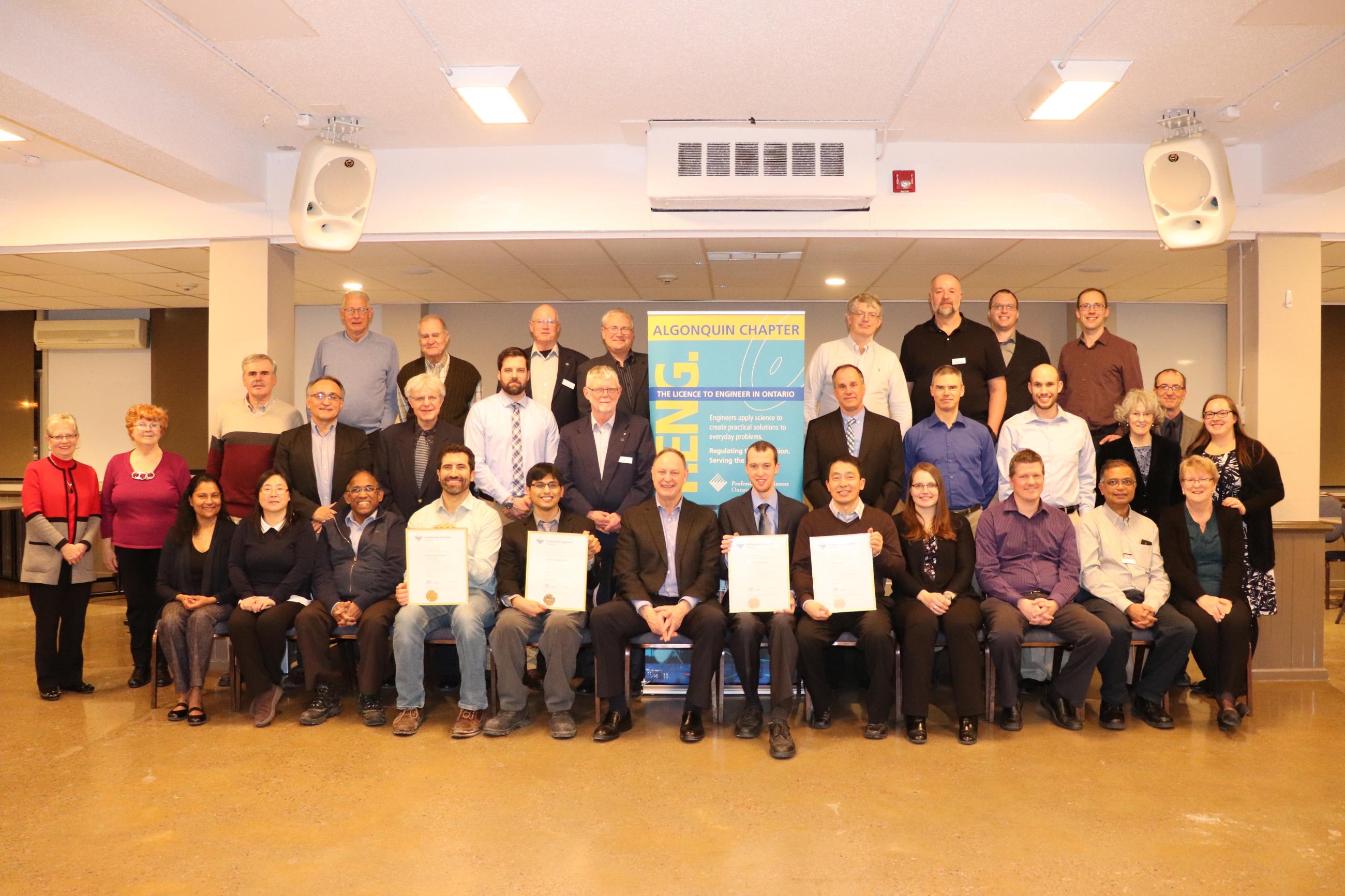 Group of people posing for photos at Annual General Meeting